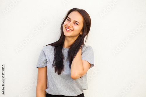 Happy brunette woman in gray t-shirt