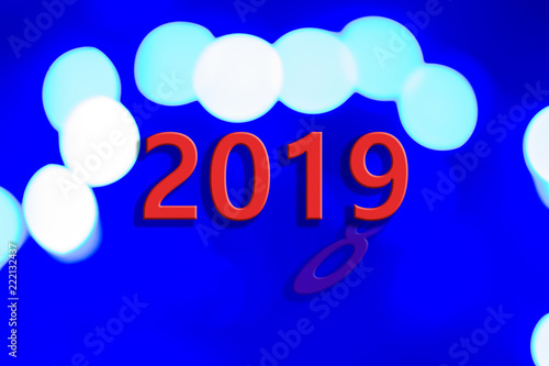 New Year and Christmas celebrating concept design of abstract glare illumination sparkles with inscription "2019" and creative conversion from "2018"