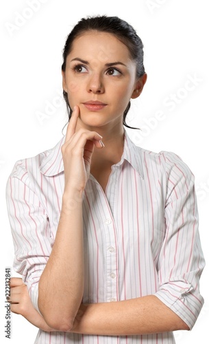 Serious looking brunette with her hand resting on her chin © BillionPhotos.com