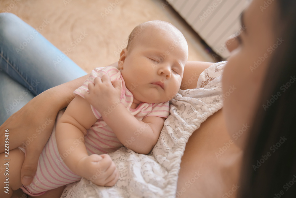 Mother with her sleeping baby at home Mother with her sleeping baby at home