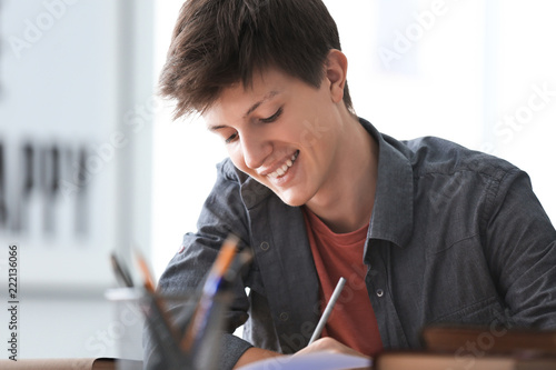 Happy teenager boy doing ho...