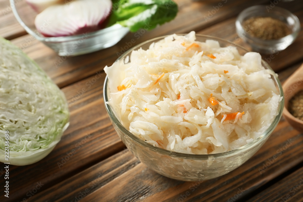 Bowl with delicious sauerkraut on wooden table Bowl with delicious sauerkraut on wooden table