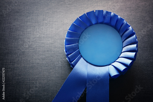Blue award rosette with ribbons and copy space photo