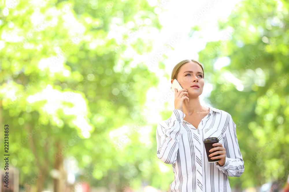 Young businesswoman talking by mobile phone outdoors Young businesswoman talking by mobile phone outdoors