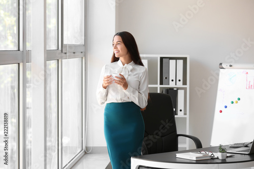 Young businesswoman drinkin...