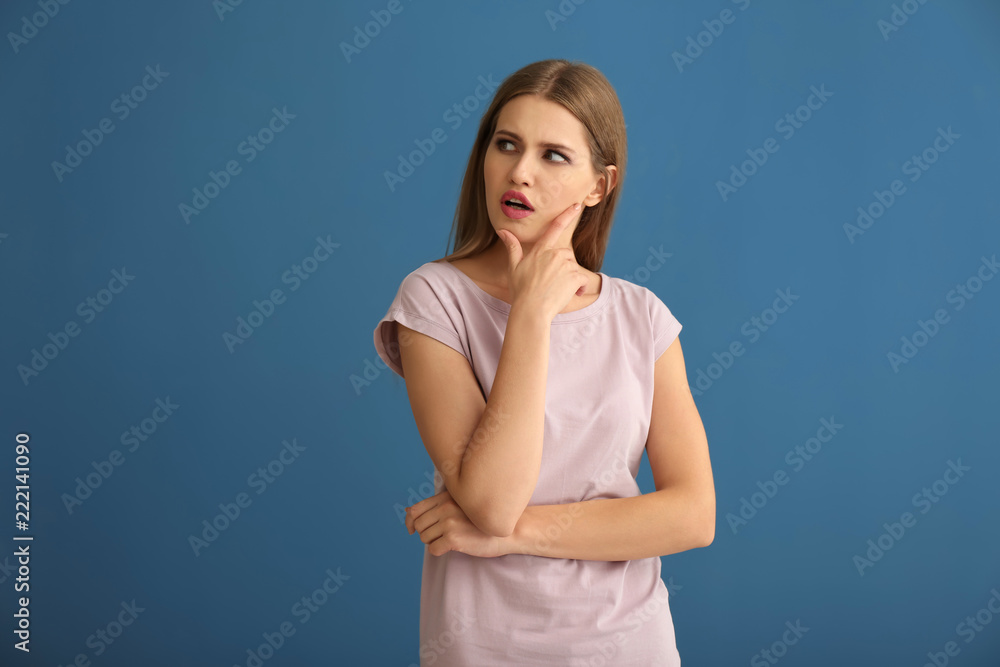 Thoughtful young woman on color background Thoughtful young woman on color background
