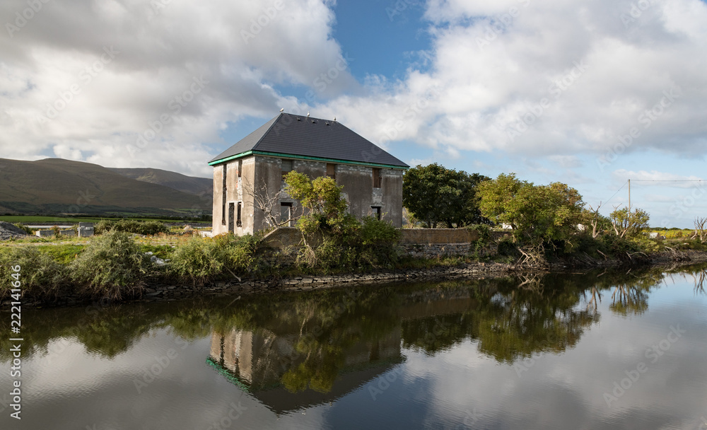 Abandonned house reflected in a river canal near Blennerville on the Dingle peninsula Abandonned house reflected in a river canal near Blennerville on the Dingle peninsula