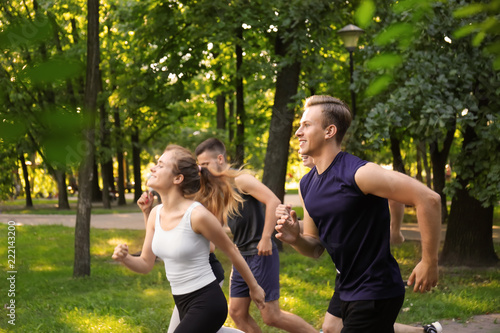 Fototapeta Naklejka Na Ścianę i Meble -  Young sporty people running outdoors