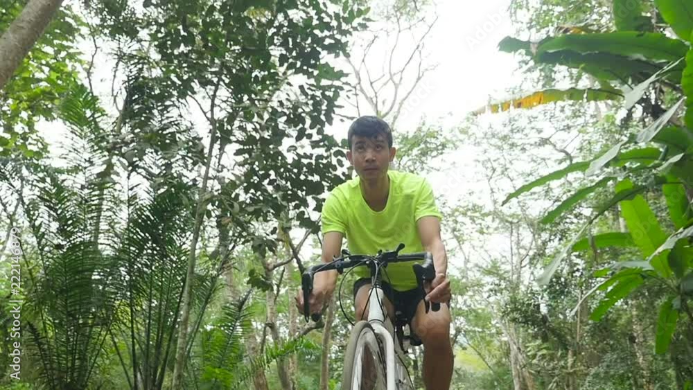 Man Riding On Bicycles At The Forest Road Man Riding On Bicycles At The Forest Road