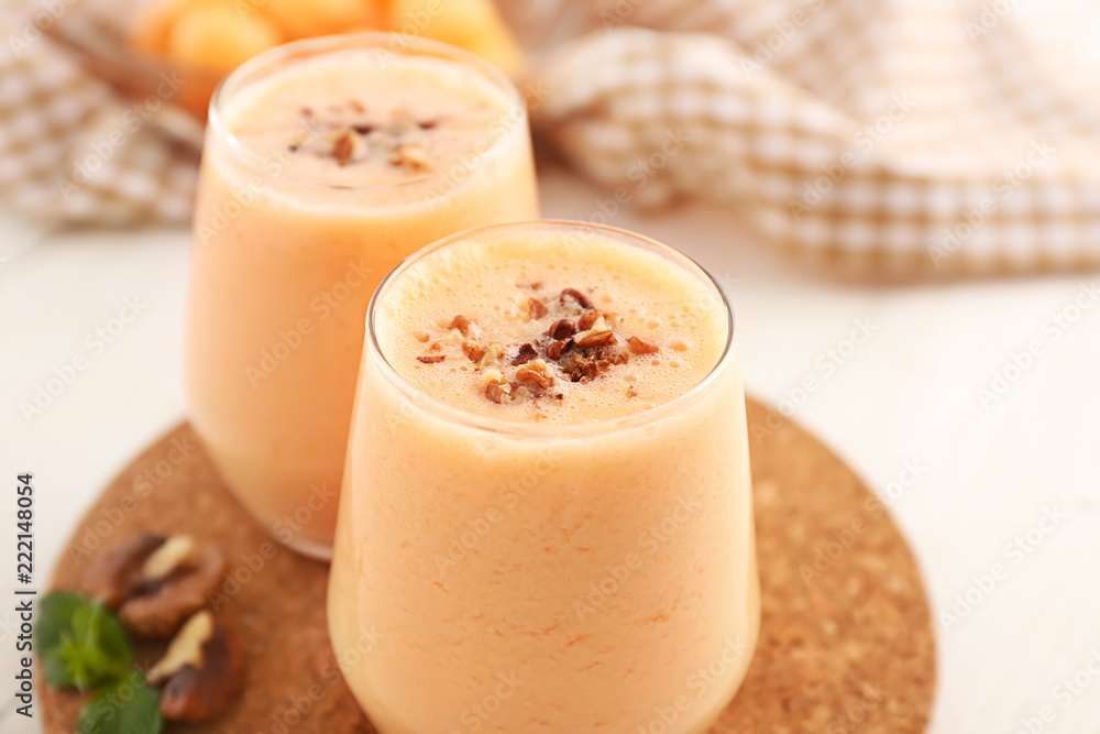 Glasses with tasty fresh melon smoothie on white table, closeup Glasses with tasty fresh melon smoothie on white table, closeup