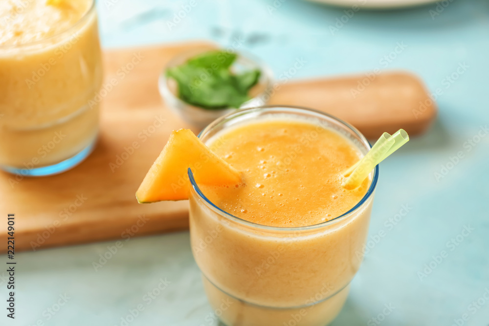 Glass of tasty melon smoothie on table, closeup Glass of tasty melon smoothie on table, closeup