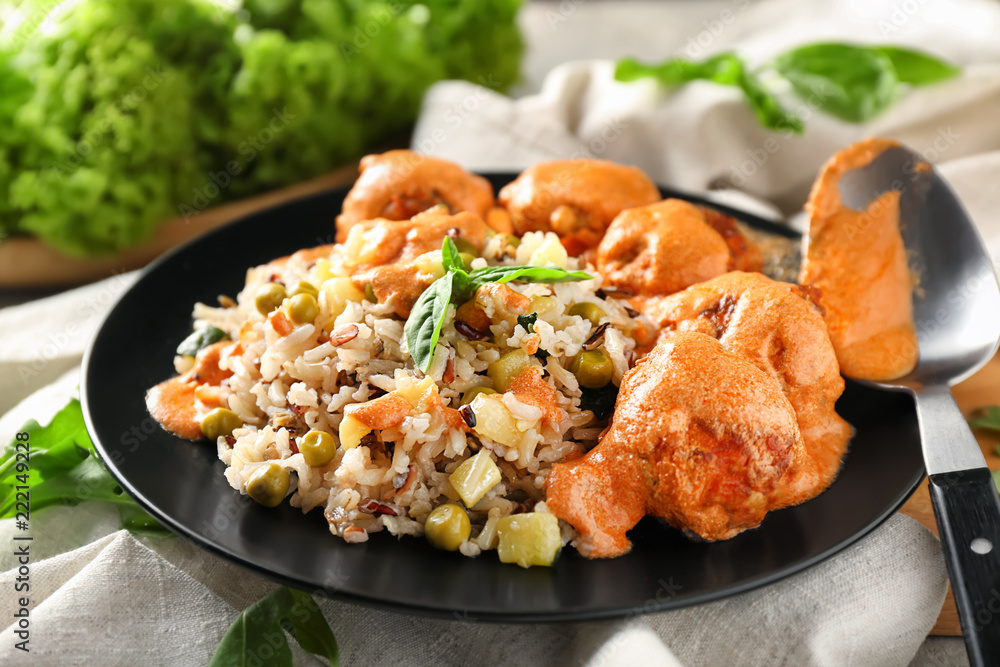 Plate with boiled rice, vegetables and meatballs on table Plate with boiled rice, vegetables and meatballs on table