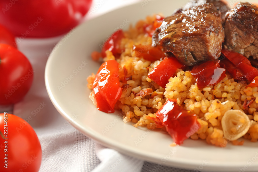 Plate with boiled rice, meat and sweet pepper on table, closeup Plate with boiled rice, meat and sweet pepper on table, closeup