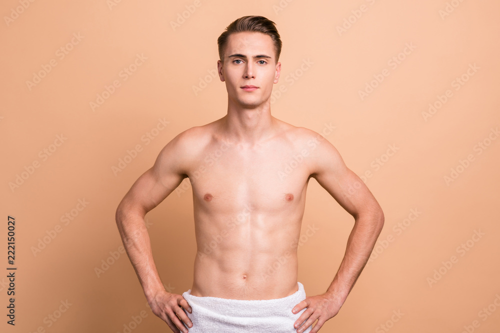Fototapeta premium Portrait of handsome man with towel, naked torso, looking relax