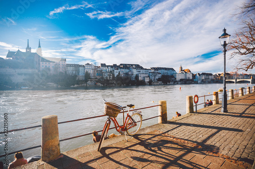 Foto city bicycle with a basket on the steering wheel of red color on the quay near t
