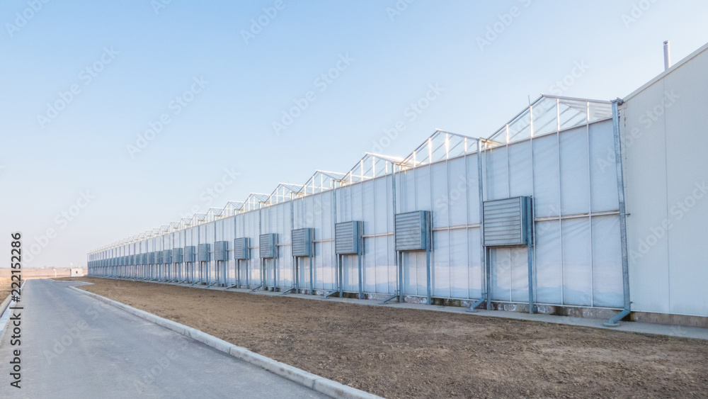 greenhouse facade with air conditioning and air ducts outside greenhouse facade with air conditioning and air ducts outside