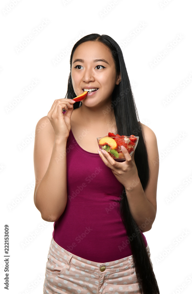 Asian woman with healthy fruit salad on white background Asian woman with healthy fruit salad on white background