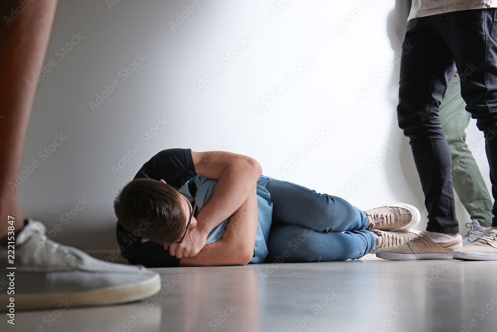 Aggressive teenagers bullying boy at school Aggressive teenagers bullying boy at school