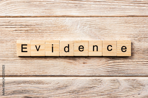 evidence word written on wood block. evidence text on table, concept photo