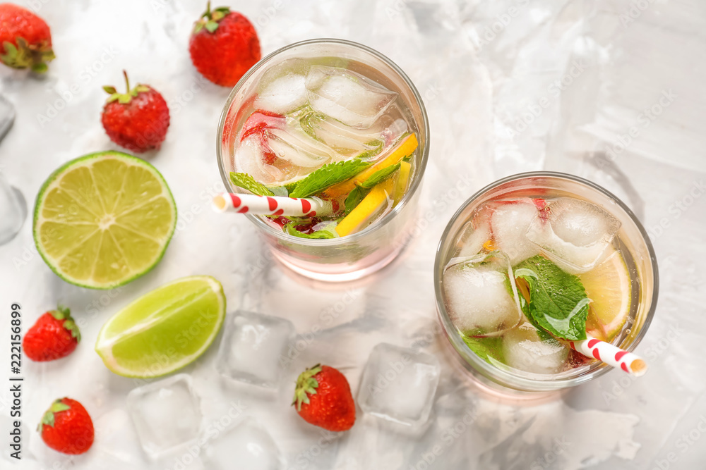 Glasses of fresh strawberry lemonade on light table Glasses of fresh strawberry lemonade on light table