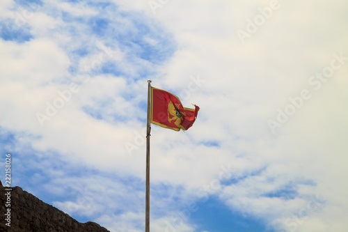 Flag of Montenegro against blue sky