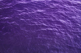 ultraviolet sea water surface with purple waves background.