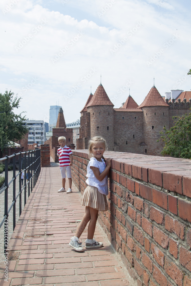 Obraz premium Outdoor portrait of young beautiful boy and girl posing on old street. Old Warsaw, Poland, summer