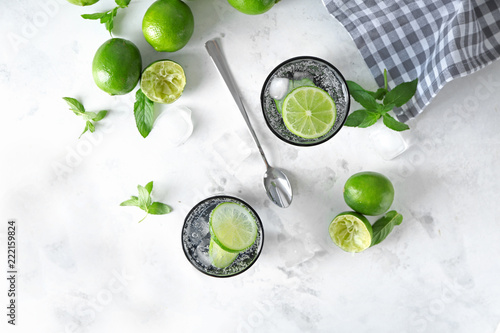 Glasses of fresh lime lemonade on light table