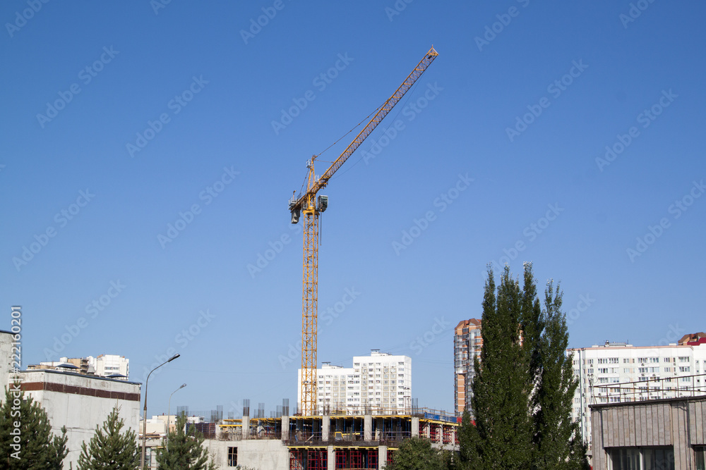 example of point construction in a residential area. crane on the site of the building under construction
