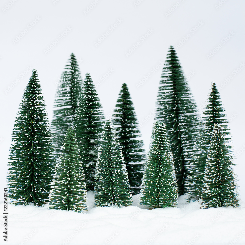 Obraz premium Christmas trees on the snow in winter. Christmas holiday celebration and new year concept. copy space