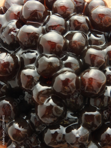 Top view and close up of black tapioca ball (also known as boba in bubble tea) which is ingredients for making pearl milk tea, other Taiwanese drink and shaved ice at dessert shop. Food background.