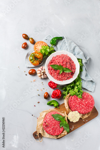 Homemade raw organic minced beef meat burger cutlet and vegetables