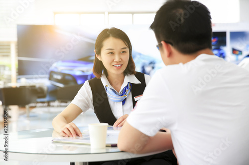 Asian car sales staff is introducing with customers © jeson