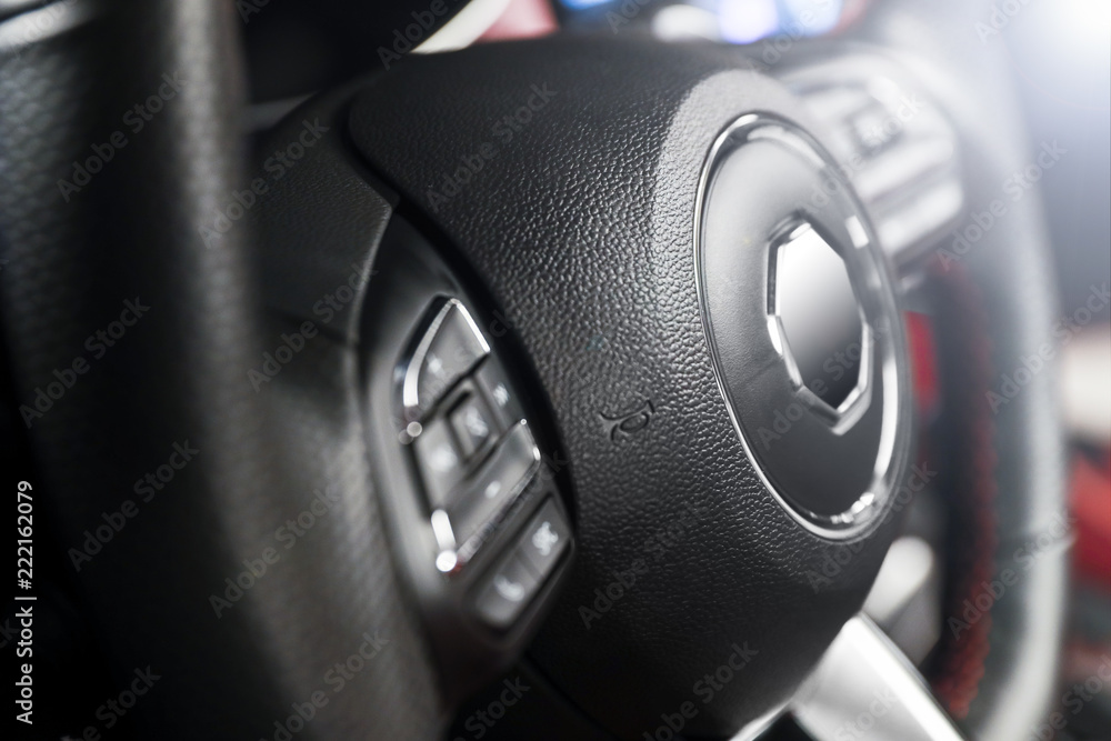Car interior steering wheel partial close-up