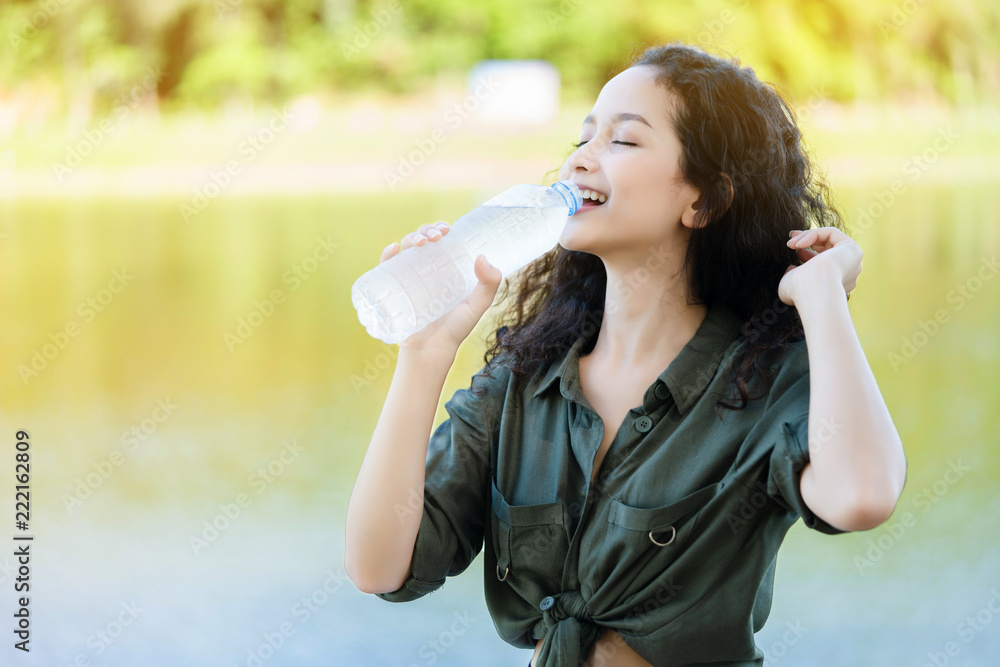 Asian women are drinking clean water. To refresh the body from hot weather in the summer. Feels good And does not cause Heat Stroke. It improves metabolism. boosts energy. Skin looks soft. Rejuvenate Asian women are drinking clean water. To refresh the body from hot weather in the summer. Feels good And does not cause Heat Stroke. It improves metabolism. boosts energy. Skin looks soft. Rejuvenate
