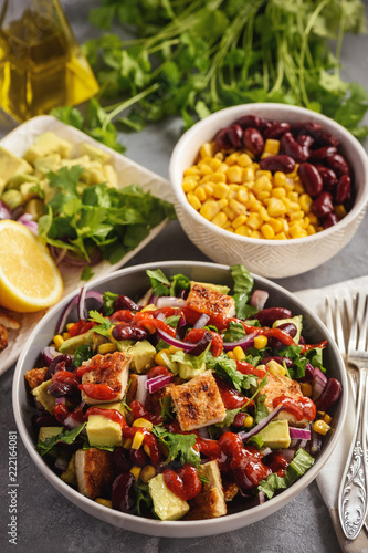 Chicken salad with avocado, corn and bean.