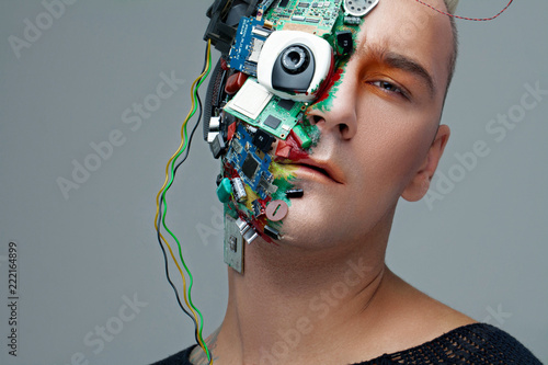 Studio photo of man cyborg, half face computer elements and with professional make-up, white Iroquois on head. Future technology concept