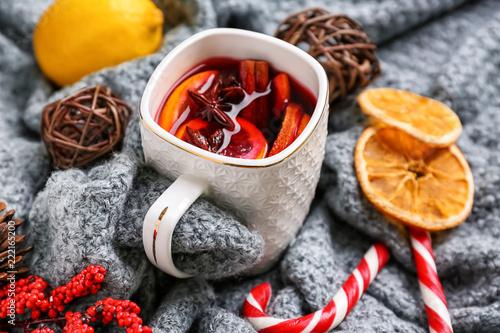 Cup of delicious mulled wine on warm plaid