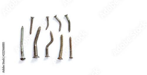 Deformed damaged metal screws collection on a white background. close-up photo, copy space