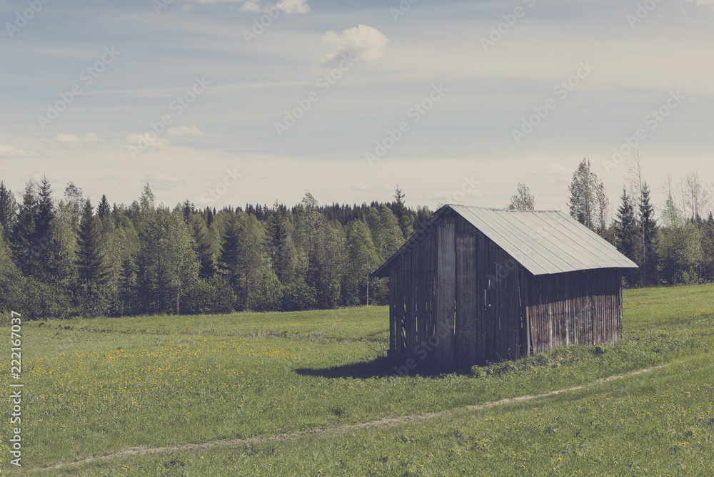 Old barn in the field. Image has a vintage effect applied. Old barn in the field. Image has a vintage effect applied.