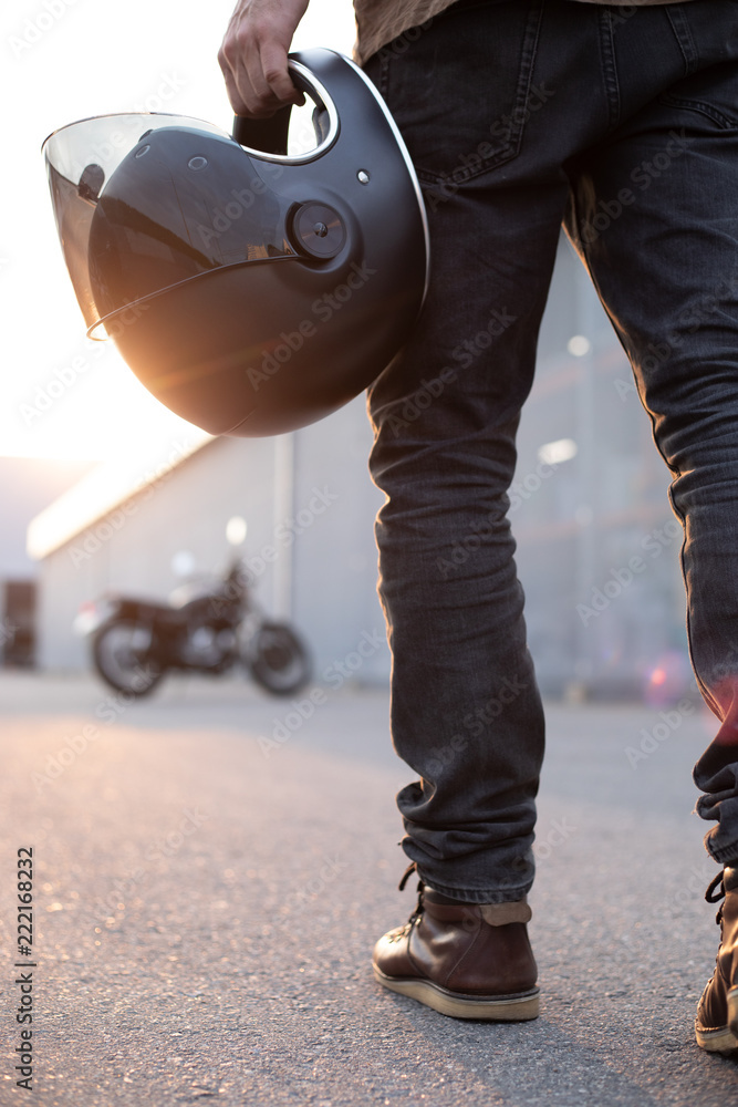 Fototapeta premium biker guy in front of classic style motorcycle