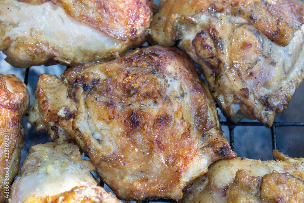 smoked meat grilled,smoked chicken meat on a grid in the nature