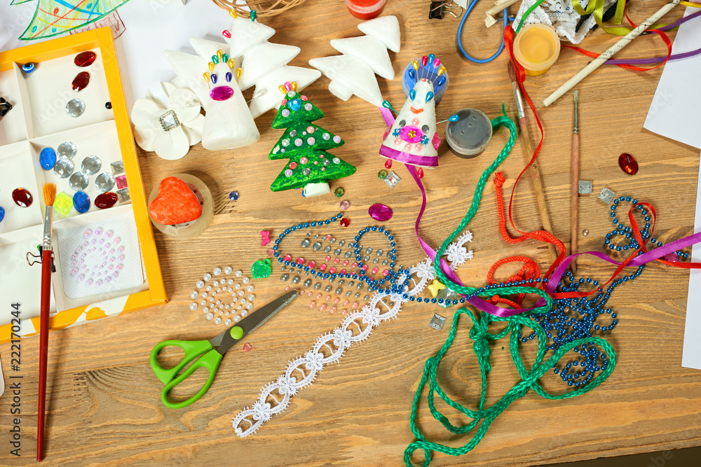 Fototapeta premium Handmade decorations for new year and other holidays. Artwork workplace with creative accessories.