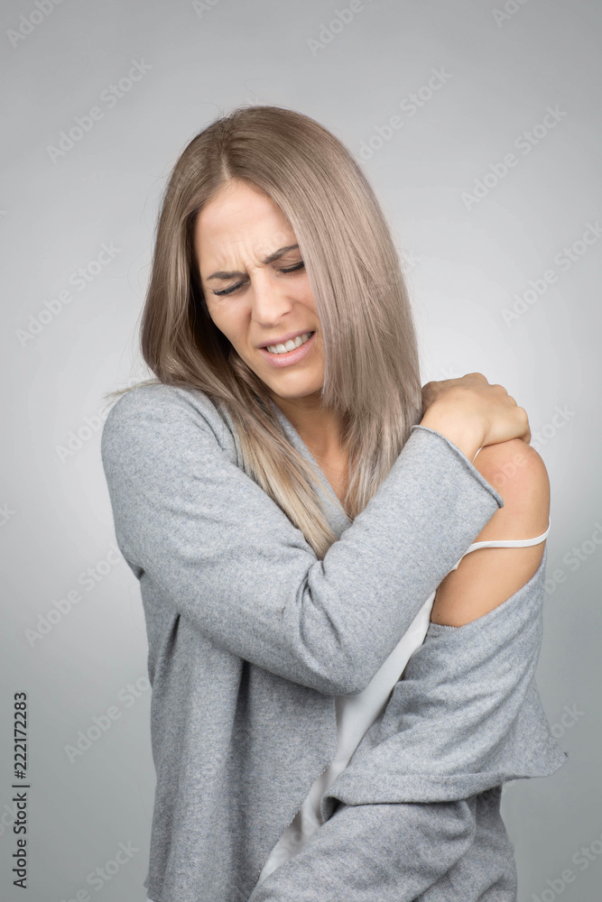 young blond woman has a painful shoulder young blond woman has a painful shoulder