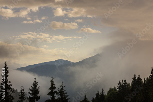 Summer mountain scenery with mist clouds, at sunset © Calin Tatu