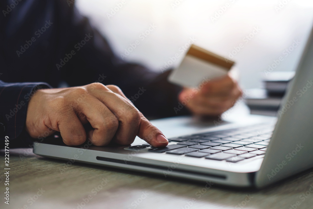 Man typing laptop for online shopping and pay by credit card, Online payment and shopping concept Man typing laptop for online shopping and pay by credit card, Online payment and shopping concept