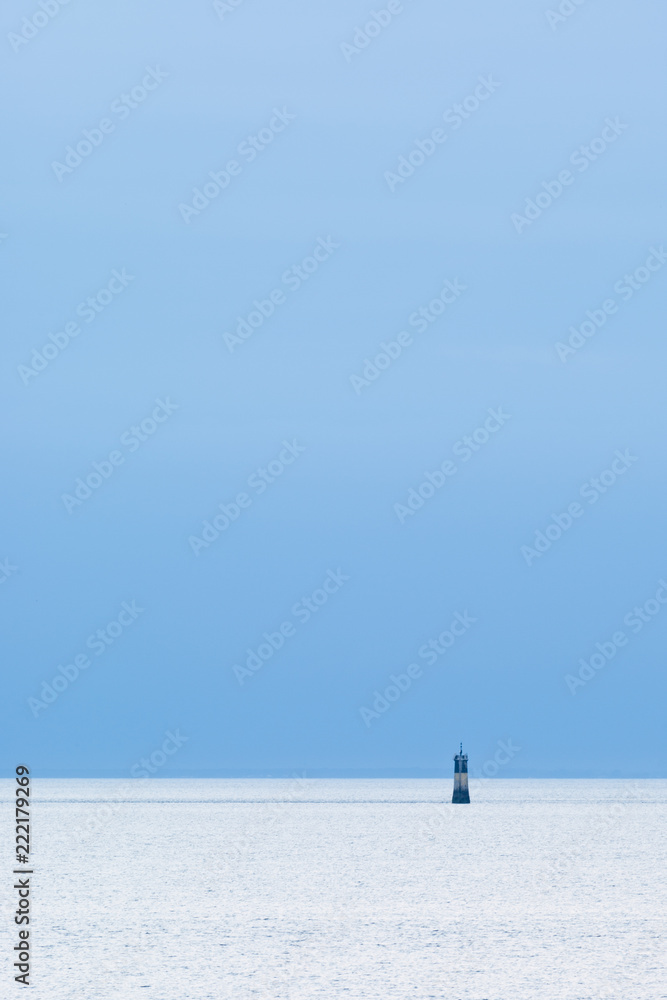 Small and Lonely Lighthouse on the horizon.