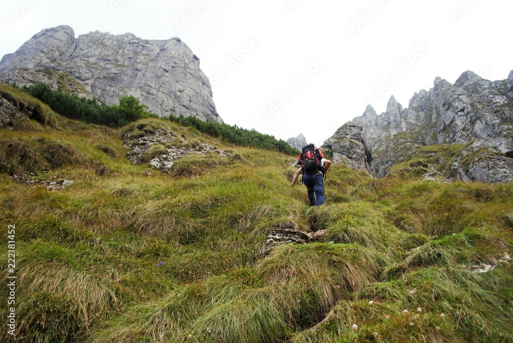 Image with a backpack traveler tracking on the mountain Image with a backpack traveler tracking on the mountain