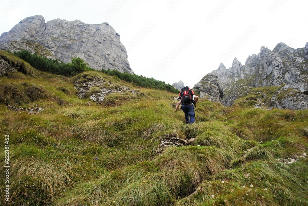 Image with a backpack traveler tracking on the mountain