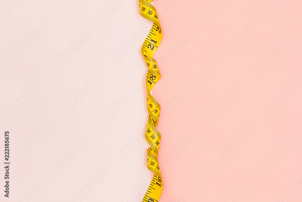 Half pink half white background with tape measure in the middle Stock Photo Adobe Stock